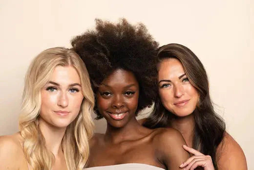 a group of three women standing next to each other